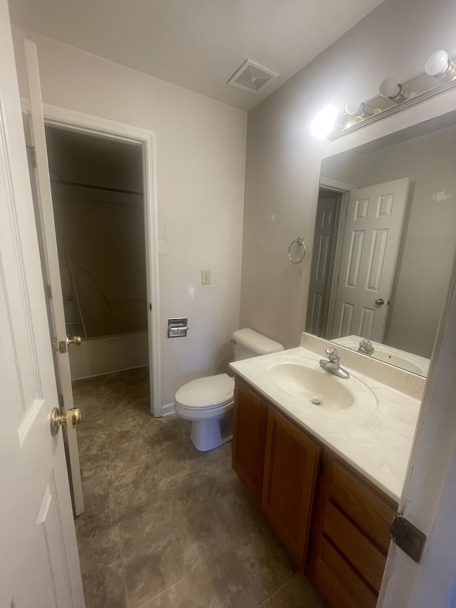 bathroom featuring walk in shower, vanity, and toilet