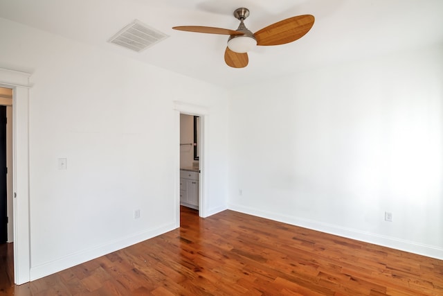 unfurnished room with ceiling fan and dark wood-type flooring