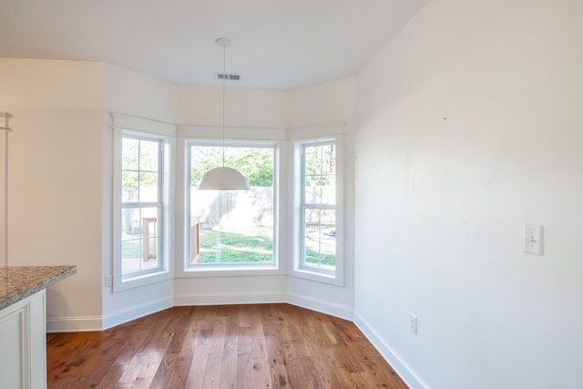 unfurnished dining area featuring light hardwood / wood-style flooring