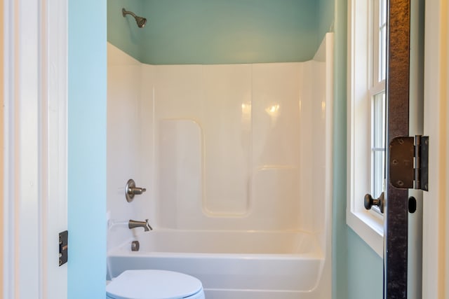 bathroom featuring toilet and tub / shower combination