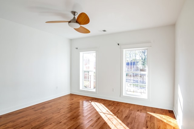 unfurnished room with ceiling fan and hardwood / wood-style flooring