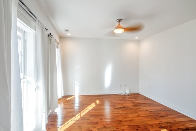 spare room featuring hardwood / wood-style flooring and ceiling fan