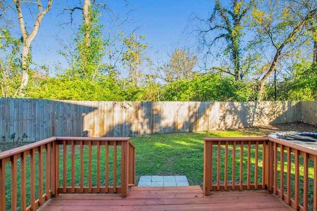 wooden terrace featuring a lawn