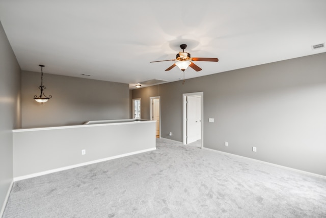 spare room with light carpet and ceiling fan