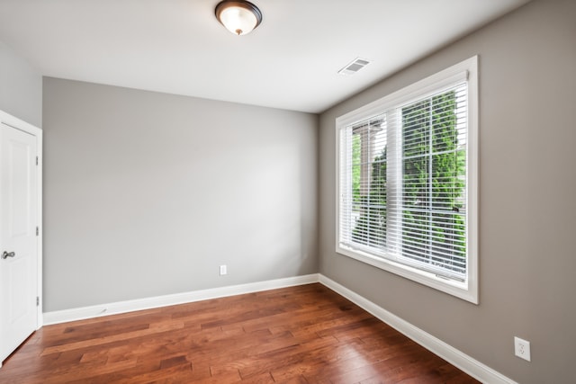 empty room with dark hardwood / wood-style floors