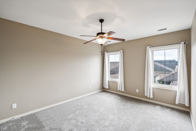 carpeted spare room with ceiling fan