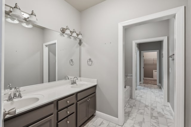 bathroom featuring a washtub and vanity