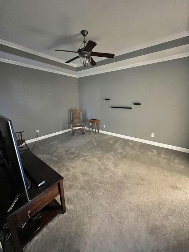 unfurnished room with carpet flooring, a raised ceiling, crown molding, and ceiling fan