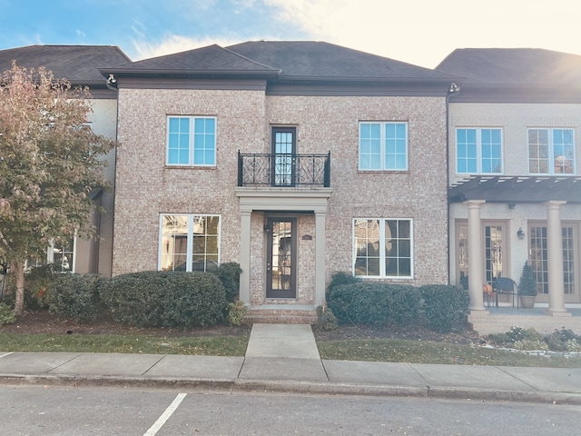 view of front of property featuring a pergola and a balcony