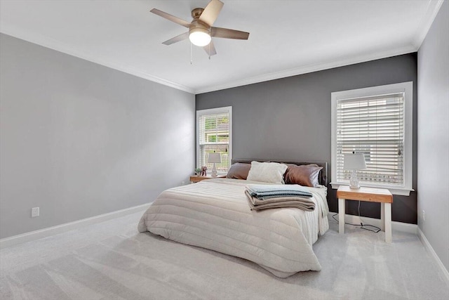 carpeted bedroom with ceiling fan and crown molding