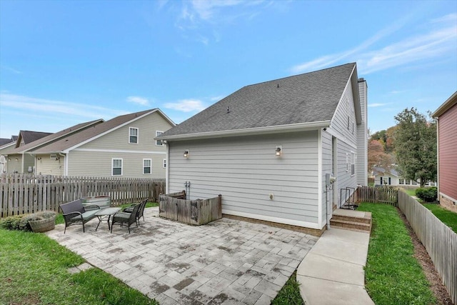 rear view of house featuring outdoor lounge area and a patio