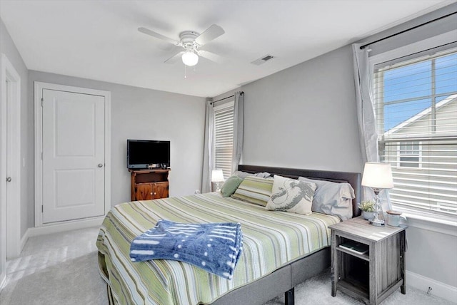 bedroom with ceiling fan and light carpet