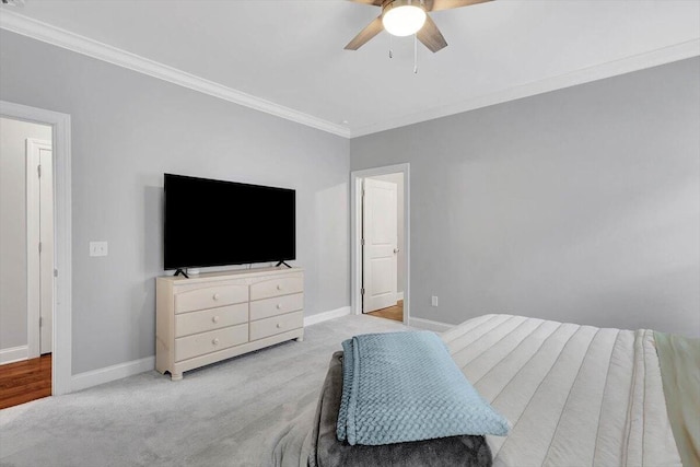 bedroom featuring ceiling fan, light colored carpet, and ornamental molding