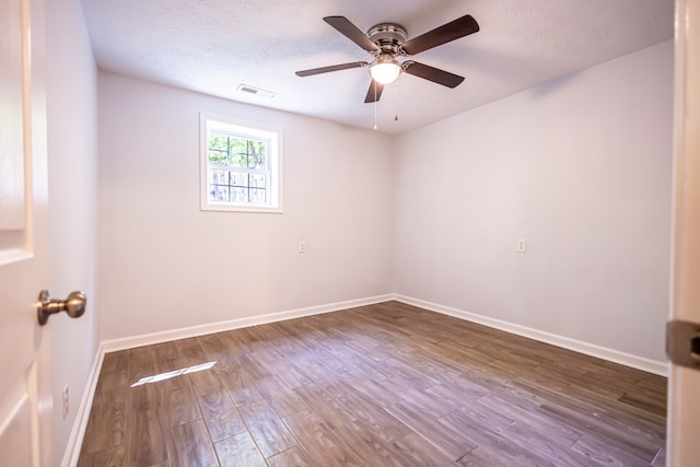 empty room with wood-type flooring, a textured ceiling, and ceiling fan