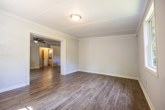 empty room with ceiling fan, crown molding, and dark wood-type flooring