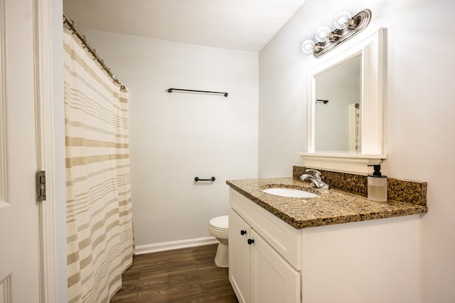 bathroom featuring hardwood / wood-style floors, vanity, and toilet