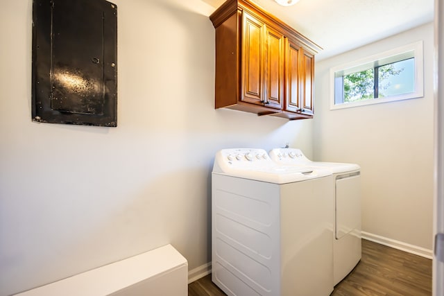 washroom featuring cabinets, independent washer and dryer, and dark hardwood / wood-style floors