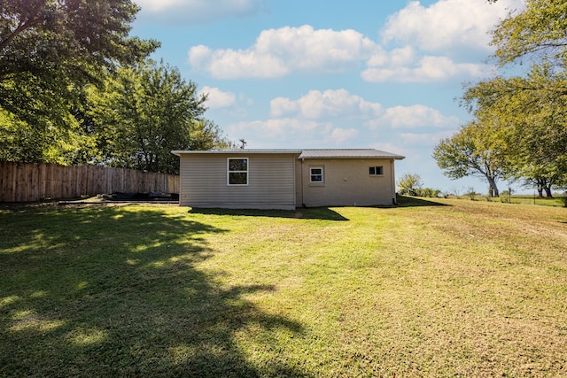 rear view of property with a lawn