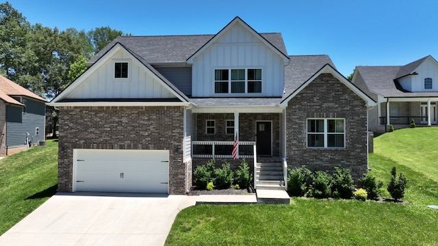 craftsman house featuring covered porch, board and batten siding, and brick siding