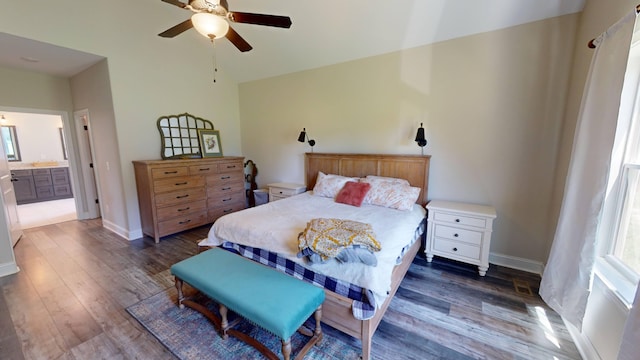 bedroom with ceiling fan, ensuite bath, wood finished floors, and baseboards