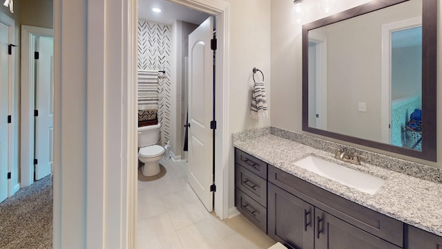 bathroom featuring toilet and vanity