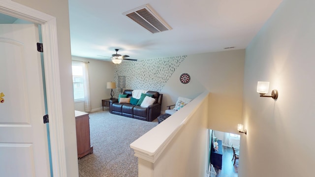 interior space featuring a ceiling fan, visible vents, and baseboards