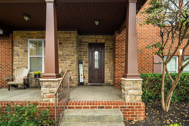 view of exterior entry with a porch