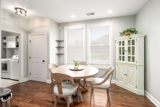 dining room featuring washer and dryer and dark hardwood / wood-style flooring