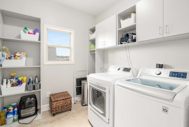 laundry area featuring cabinets and washing machine and dryer