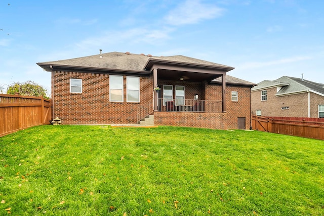 rear view of house featuring a lawn