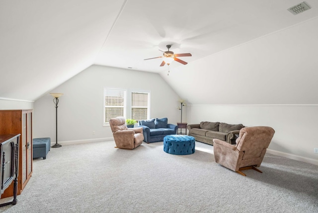 carpeted living room with ceiling fan and vaulted ceiling