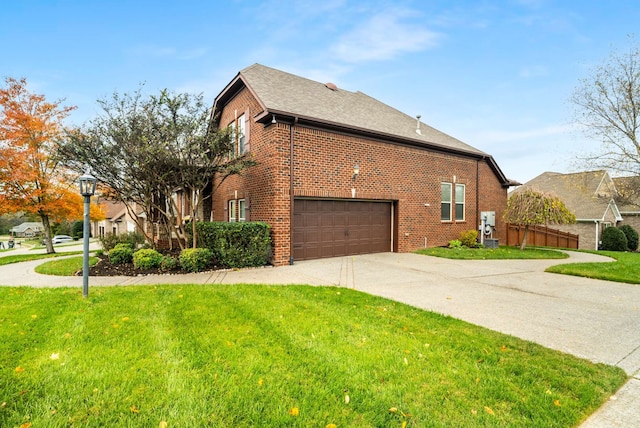 view of side of home featuring a lawn and a garage