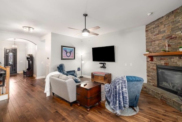 living room with ceiling fan, a fireplace, and dark hardwood / wood-style floors