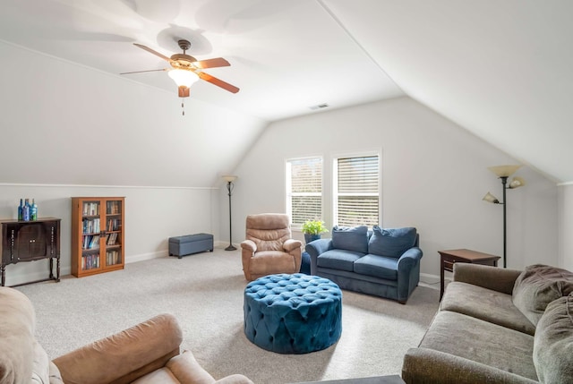 carpeted living room with ceiling fan and lofted ceiling