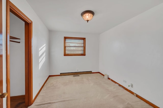 empty room featuring carpet floors and a baseboard radiator