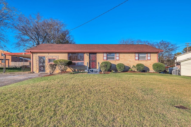 ranch-style home featuring a carport and a front lawn