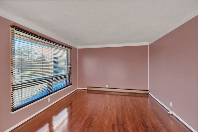 spare room with wood-type flooring, ornamental molding, and a baseboard radiator