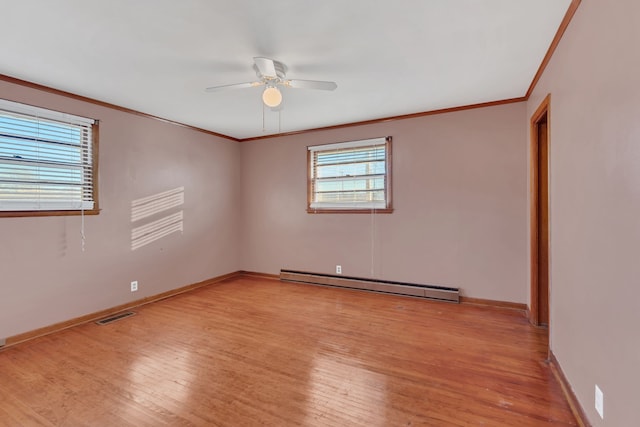 empty room with ceiling fan, light wood-type flooring, ornamental molding, and a baseboard heating unit