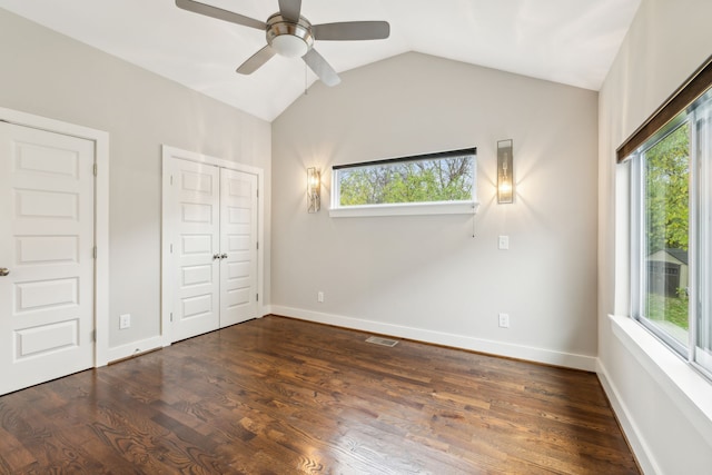 unfurnished bedroom with dark hardwood / wood-style floors, multiple windows, lofted ceiling, and ceiling fan