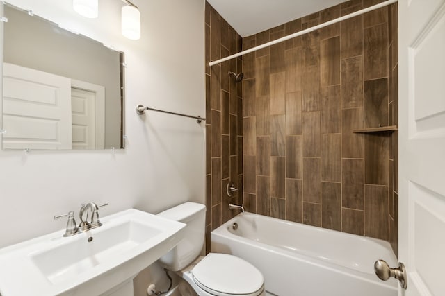 full bathroom with tiled shower / bath combo, toilet, and sink