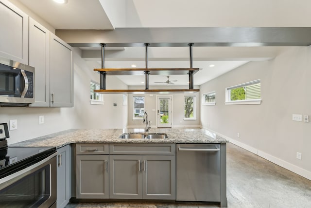 kitchen with gray cabinetry, concrete flooring, stainless steel appliances, ceiling fan, and sink