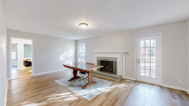 interior space featuring light hardwood / wood-style floors and a brick fireplace