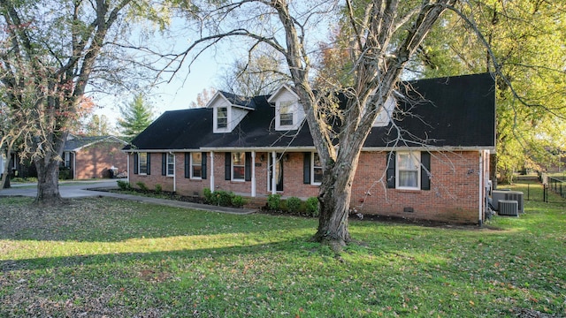 cape cod-style house with central AC and a front yard