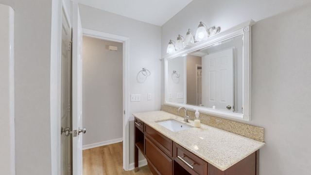 bathroom with hardwood / wood-style floors and vanity