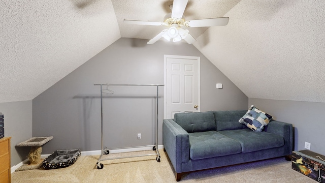 interior space with carpet flooring, ceiling fan, a textured ceiling, and vaulted ceiling