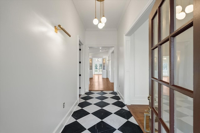 hallway with an inviting chandelier and crown molding