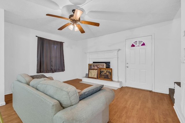 living room featuring ceiling fan and light hardwood / wood-style flooring