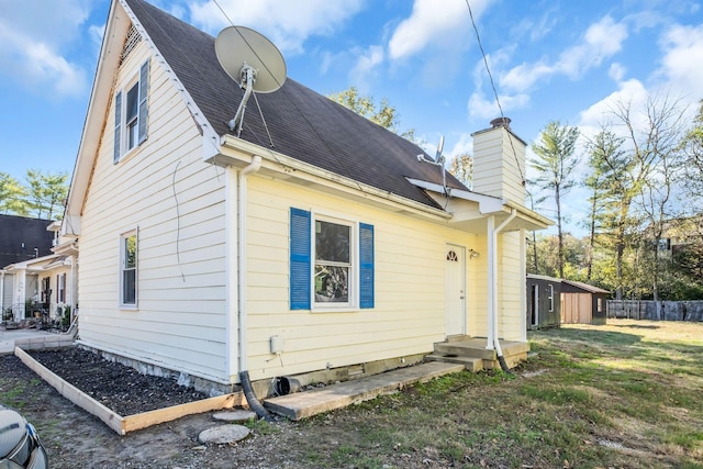 back of property featuring a yard