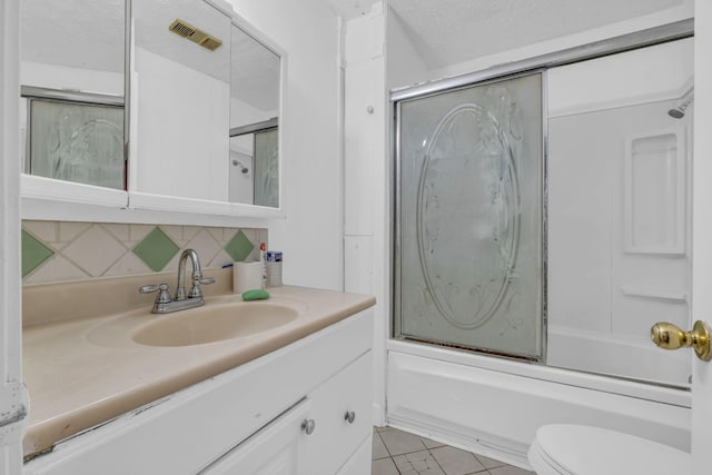 full bathroom with combined bath / shower with glass door, backsplash, tile patterned floors, vanity, and a textured ceiling