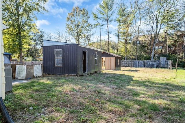 view of yard with cooling unit and an outdoor structure